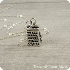 This Cheese Grater Necklace comes on a sterling silver chain that is available in different lengths. Please choose your desired length from the drop-down menu when placing the item in your shopping cart. { CHARM DETAILS }★ Material: .925 Sterling Silver★ Finish Color: Silver★ Measurements: 1/4" x 1/2"★ Dimensions: 3-Dimensional★ Made in the USA{ SIMILAR ITEMS } More food and kitchen themed items available from my shop: https://www.etsy.com/shop/treasuredcharms/search?search_query=food{ GIFT OPTI Themed Sterling Silver Charm Necklaces, Themed Sterling Silver Necklace, Themed Sterling Silver Necklace In Silver, Themed Sterling Silver Nickel Free Necklaces, Themed Sterling Silver Nickel-free Necklace, Adjustable Themed Sterling Silver Necklace, Silver Themed Pendant Jewelry, Themed Silver Pendant Jewelry, Themed Sterling Silver Jewelry As Gift