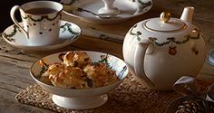 a table topped with plates and bowls filled with food on top of a wooden table