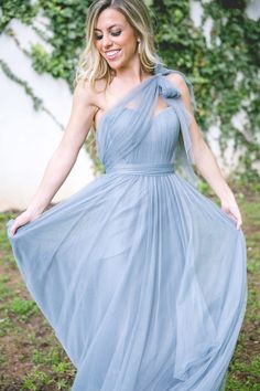 a woman in a blue dress posing for the camera