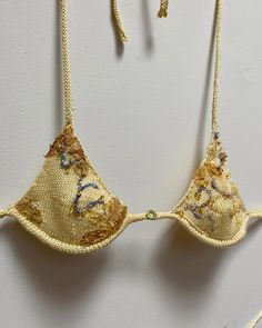 Ready for GRACE GUI SS24? Bikini set knit with 100% botanically dyed silk yarn, embroidered with wild foraged silk cocoons, beaded with 100% sea glass, felted with 100% tussah silk, topped off with removable underwire for support, and a sweet 100% genuine Jade pendant in the middle. #GRACEGUISS24 #BotanicalSilk #EmbroideredBikini #WildForagedCocoons #SeaGlassBeaded #TussahSilk #nycfashion#EcoFashion #SustainableStyle #JadePendant #HandcraftedSwimwear #HandmadeSwimwear#naturaldyes #nyc Knitted Swimsuit Bikinis, Embroidered Swimsuit, Beaded Clothes, Handmade Swimwear, Unique Bikinis, Knitted Swimsuit, Ibiza Outfits, Textiles Projects, Swimsuit Brands