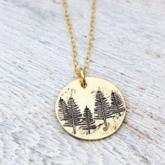 "Tree Necklace - Forest Necklace - Gift for Her - Stocking Stuffer - Winter Birthday Necklace - Pine Tree Necklace - Evergreen Jewelry 5/8\" brass disk is stamped with little pine trees, and given a rustic finish. It hangs from a dainty gold filled cable chain." Personalized Nature-inspired Charm Necklace For Gifts, Handmade Round Charm Necklace For Birthday, Green Pendant Jewelry For Birthday, Handmade Green Necklaces For Birthday Gift, Handmade Green Necklace For Birthday Gift, Gold Nature-inspired Necklace For Gift, Green Birth Flower Jewelry As Gift, Green Birth Flower Jewelry Gift, Green Birth Flower Jewelry For Gift