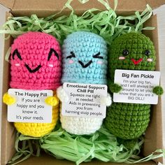 three crocheted items in a cardboard box