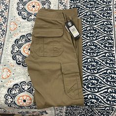 Brand New Under Armour Storm Cargo Pants Fitted Khaki Pants For Outdoor, Fitted Khaki Bottoms For Outdoor, Fitted Pants With Side Pockets For Outdoor, Fitted Khaki Pants With Side Pockets, Fitted Tapered Leg Pants For Outdoor, Under Armour Bottoms With Pockets, Fitted Khaki Work Pants With Pockets, Fitted Khaki Work Pants, Under Armour Outdoor Pants With Pockets