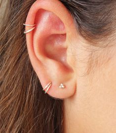 An dainty and simple hoop earring perfect for adding a detail to your earlobe. Extremely versatile and they're perfect to style up many ear piercing ( rook, tragus, cartilage, earlobe...). This earring is sold as a single hugger. Dainty, Minimalist and On Trend the Rainbow CZ Ear Cuff is the perfect addition to any ear party. Add some extra bling to your ears without the commitment of a new piercing! This list is for single hoops. Please select how many hoops you want in the Quantity/Diameter dr Simple Hoop Cartilage Single Earring, Dainty Hoop Wrap Earrings For Pierced Ears, Dainty Hoop Wrap Earrings, Daith Piercing Jewelry, Bold Statement Necklaces, Daith Earrings, Simple Hoop Earrings, Tiny Hoop Earrings, Chic Bracelet