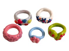 four different colored rings with flowers on them