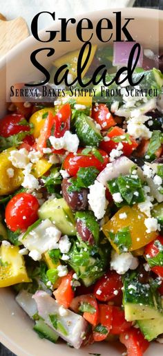 greek salad served in a white bowl with feta cheese and olives on top