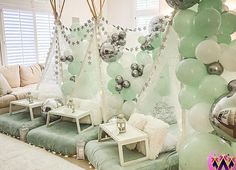 a room filled with lots of balloons and decorations