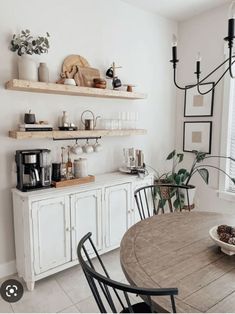 a dining room table and some shelves above it