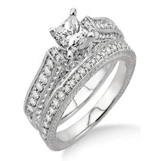 a wedding ring set with a princess cut diamond in the center and side stones on each band