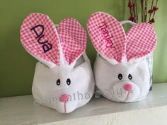 two stuffed rabbits with pink ears and the word dad written on them are sitting next to each other