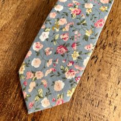 Beautiful ditsy floral tie in blue grey, pink and white. This 100% viscose tie would look so lovely at a spring or summer wedding, either for the groom, groomsmen, ushers or wedding guests. The fabric is soft to the touch and the colours look amazing together. Material: 100% viscose Size: 146cm x 6cm This item will be hand gift wrapped before posting. Fitted Blue Floral Suit And Tie Accessories, Dapper Adjustable Ties For Spring, Adjustable Dapper Tie For Spring, Adjustable Dapper Ties For Spring, Spring Blue Floral Print Suit And Tie Accessories, Blue Floral Print Suit And Tie Accessories For Spring, Classic Floral Suit And Tie Accessories For Spring, Classic Floral Print Suit And Tie Accessories For Spring, Dapper Suit And Tie Accessories For Spring Wedding