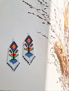 A pair of earrings inspired by patterns of Icelandic knitted shoe inserts. I recreated a pattern from one of the exhibits I saw at the National Museum Of Iceland in Reykjavik. In the old days wool shoe inserts were worn in soft shoes made of sheep and fish skin for extra comfort and warmth.  These earrings are my own, unique way of preserving the traditional folk pattern.  They are made of small glass beads and the ear studs are made of sterling silver. White Woven Earrings For Gift, Traditional Woven Multicolor Earrings, Traditional Multicolor Woven Earrings, Traditional White Handwoven Beaded Earrings, Traditional Woven Earrings, Folk Art Jewelry, Folk Pattern, Jewels Diy, Handmade Beaded Earrings