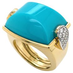 The natural radiance of turquoise is the spotlight of this diamond-accented La Vallette ring. Carved in a cushion, the prized color of turquoise is displayed. Sleeping Beauty Turquoise has become a scarce gem due to low supply, yet remains a favorite with its lustrous blue hue. On the side, the drops embellished with DEF color and VVS2 clarity diamonds sparkle from each side. The diamonds are ranked just below flawless, ensuring a bright light. 18k yellow gold sets the diamonds and forms the smooth shank, showcasing the vibrant golden hue that the metal is treasured for. The total weight of the gems is 21.55 carats of turquoise and 0.44 carats of diamonds. Measurements for the ring are 0.875 inches (width) by 0.625 inches (length) by 0.375 inches (depth). Luxury Fine Jewelry Turquoise Ring With Diamond Accents, Turquoise Diamond Ring, Turquoise Diamond Rings, Genie Bottle, Yellow Gold Setting, Sleeping Beauty Turquoise, Bright Light, Blue Hues, Fashion Rings