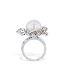 Glamorous and timeless, this 14 kt white gold South Sea Pearl Diamond Estate Ring is a luxurious piece to marvel at. Gracing the center is a 12.55mm pearl, radiating with its exquisite beauty and flanked by diamond pave for an added sparkle. South Sea Pearl Diamond White Gold Estate Ring 14kt White gold 12.55mm South Sea Pearl in the center Diamond Pave: stamped) G/H SI2 0.83ct Diamond Pave Size 6.5 Estate and Vintage Collection SKU: 21469 Estate Ring, Estate Rings, Sea Pearl, South Seas, South Sea Pearls, Sea Pearls, Pearl Diamond, Selling Jewelry, Pave Diamonds