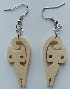 the wooden earrings are shaped like an angel