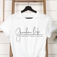 a white t - shirt with the words grandma life printed on it next to a plant