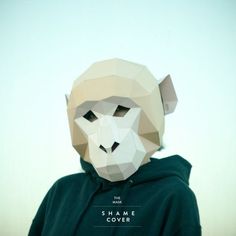 a person wearing a paper mask with the words shame cover on it