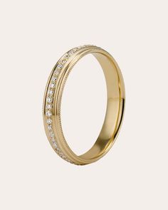 a gold wedding ring with white diamonds