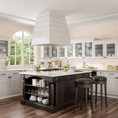 a large kitchen with white cabinets and black island in the center, surrounded by bar stools