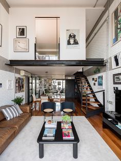 a living room filled with furniture and a stair case