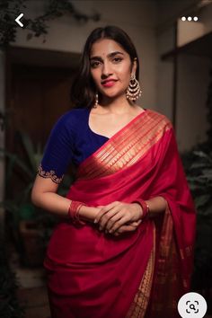 a woman wearing a red and blue sari