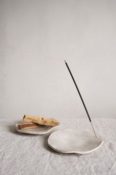 two white plates with sticks sticking out of them