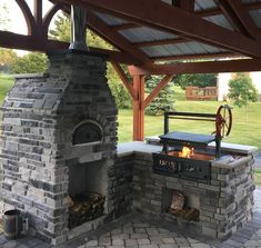 an outdoor kitchen with a brick oven and grill