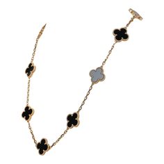 This Van Cleef & Arpels Vintage Alhambra 10 Motif Necklace is in 18k gold with 10 onyx motifs and a lobster claw clasp.Origin: FranceCondition: New and never wornAccompanied by: VCA green jewelry box, box and authenticity card Measurements: 16.5" x .5" Designer Black Necklace As A Gift, Designer Black Necklace For Gift, Designer Black Necklaces For Gift, Designer Yellow Gold Jewelry With Black Enamel, Luxury Silver Necklace With Black Enamel, Fine Jewelry White Gold Necklace With Black Enamel, Luxury 14k Gold Jewelry With Black Enamel, Designer Black Enamel Jewelry, Designer Black Jewelry With Black Enamel