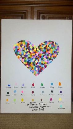 a heart made out of colored confetti on a white paper with the date 2013 - 2013