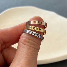 This is a personalized dark engraved Chinese name ring in stainless steel. Please see below for more details on sample rings.  Rose: Abigail in Chinese font #5 Gold: Julia in Chinese font #2 with a heart Original: Alexander in Chinese font #1 Please check the font options in the pictures: fonts #3, 4, and 5 are written in Traditional Chinese only, and #6 is written in Simplified Chinese only. #1 and 2 is available for both Traditional and Simplified Chinese. Simplified Chinese will be used for the font #1 & 2 if you don't have a preference.  The ring is approximately 3 mm wide.  All orders come gift-wrapped. << How to order >> Please choose the finish, engraving side, and ring size from the options. Please leave the name, word, or phrase and font style number you want. If it's a word, clar Personalized Stainless Steel Engraved Ring For Promise, Personalized Stainless Steel Engraved Promise Ring, Personalized Stainless Steel Engraved Ring Gift, Chinese Ring, Roman Letters, Chinese Font, Chinese Name, Name Rings, Chinese Characters