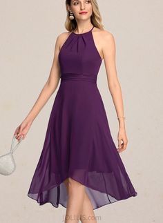 a woman in a purple dress holding a white purse