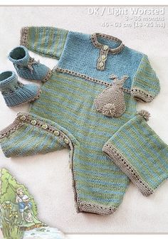 a knitted baby's outfit and booties are laying on the ground