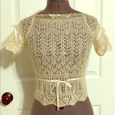 a mannequin wearing a lace top and belt