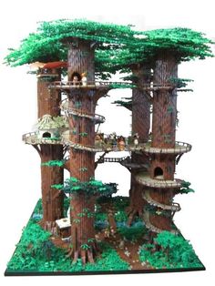 a model of a tree house made out of lego blocks and trees with people in it