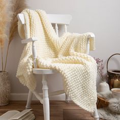 a white chair with a blanket on it