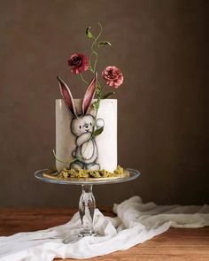 a cake decorated with an image of a rabbit and flowers