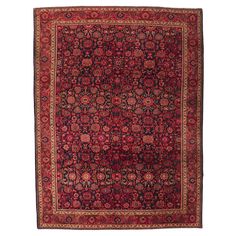 an antique persian rug with red and black floral design on the center, surrounded by smaller circular medallions