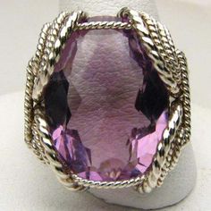 "Wire Wrapped Sterling Silver Handmade Genuine Faceted Amethyst Ring 25x18mm 12+ct View more Amethyst jewelry in our shop https://www.etsy.com/shop/JandSGems?ref=hdr_shop_menu&search_query=amethyst Sizing and shipping is ALWAYS FREE with a 14 day \"No Questions Asked\" return policy. This ring is made with real gems. I made it myself, so if you see a setting you like and want a different gem in it, I can put in another one as they are not finished. I can probably do it for the same price or Elegant Large Stone Amethyst Ring, Exquisite Silver Amethyst Ring, Elegant Purple Amethyst Ring With Large Stone, Elegant Silver Amethyst Ring With Large Stone, Elegant Faceted Purple Rings, Elegant Purple Faceted Rings, Handmade Purple Amethyst Ring For Formal Occasions, Exquisite Silver Amethyst Gemstone Ring, Unique Purple Amethyst Ring With Accent Stones