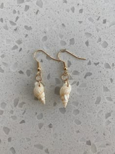 Gold natural shell earrings. Tarnish resistant. White Shell Pearl Drop Earrings, White Shell-shaped Shell Earrings, White Shell-shaped Earrings For Vacation, White Shell-shaped Pearl Earrings, Mother Of Pearl Shell Pearl Earrings For Pierced Ears, Shell-shaped Earrings With Ear Wire, Shell-shaped Shell Earrings With Ear Wire, Shell-shaped Earrings For Vacation, White Shell Earrings For Pierced Ears