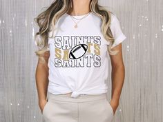 This is the perfect t-shirt for Saints Gamedays! I can guarantee you will look and feel your best wearing this tee while representing your team! These shirts are made to order since I use the latest direct-to-film (DTF) printing technology to offer high-quality prints that will maintain great color and vibrancy over time--even exceeding the color fastness of the garment itself. Keep in mind that the original manufacturer's care instructions don't take into consideration the DTF printing process. So I suggest following the care instructions on this page to learn how to take care of your printed garments properly. DTF printed apparel can be machine-washed cold, inside-out on a gentle cycle using your washer's recommended amount of detergent. You shouldn't use any fabric softeners. It can be White T-shirt For Football Season Team Events, White T-shirt With Team Logo For Team Events, White Fan Apparel T-shirt For Team Events, White Slogan T-shirt For Sports Events, Team Spirit Slogan T-shirt For Sports Season, Sunday Attire, Printed Garments, Who Dat, Dtf Printing