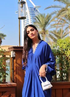 Azure blue georgette silk kaftan with details on the neckline, sleeves and back. Blue Long Sleeve Georgette Dress, Elegant Embroidered Neckline Tunic For Summer, Elegant Summer Tunic With Embroidered Neckline, Elegant Tunic Kaftan With Embroidered Neckline, Elegant V-neck Kaftan With Embroidered Neckline, Blue Summer Dresses With Cape Sleeves, Chic Blue Dresses With Cape Sleeves, Blue V-neck Kaftan For Party, Blue Silk V-neck Blouse