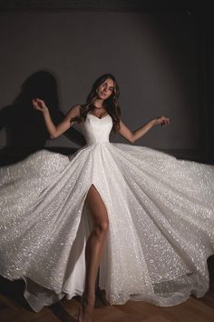 a woman in a white dress is posing for the camera with her legs spread out