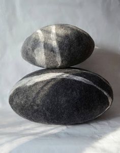 two black and white rocks sitting on top of each other