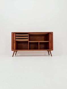 an old wooden cabinet with drawers and shelves on the front, against a white background