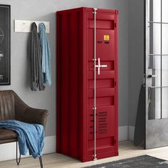 a room with a chair and a red cabinet