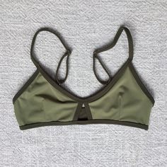 Reversible bikini top! Very comfortable for training and surfing Color - Military Green 80% - Nylon 20% - Lycra Handwash cold separately Do not wring or twist Do not dry on the sun Bottoms - https://www.etsy.com/listing/1250164300/women-swimwear-surf-pole-dance Check the size chart in photo gallery Our sizing is based on a true and snug fit. When deciding on what is the best for you, think about how tight you would like your swimwear to fit.  For all in-between sizes, or if you can not decide on Sporty Nylon Swimwear With Padded Cups, Sporty Swimwear With Padded Cups For Beach, Padded Fitted Swimwear For Workout, Sporty Stretch Swimwear With Padded Cups, Green Nylon Swimwear With Athleisure Style, Green Nylon Swimwear In Athleisure Style, Bra-friendly Nylon Swimwear For Workout, Padded Swimwear For Workout, Nylon Workout Swimwear With Bra Support