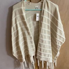 Nwt Beautiful Anthropologie Sweater Poncho With Beautiful Fringe Detailing - Very Soft Cream Casual Poncho, One Size Fits All, Cream Casual Poncho One Size, Casual White Poncho For Fall, White Summer Poncho Shawl, White Winter Vacation Outerwear, Cream Poncho For Beach In Fall, Cream Poncho For Fall Beach Trips, White One-size Cardigan For Beach, One Size White Cardigan For The Beach