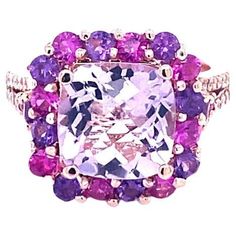 Amethyst Pink Sapphire and Diamond Cocktail Ring! Playful yet Powerful! Its like having a piece of glittery candy on your finger! This ring has a light purple Cushion Cut Amethyst that weighs 4.06 Carats and is embellished with 20 Pink Sapphires and Amethysts that weigh 1.31 Carats. The shank is accented by 36 Round Cut Diamonds that weigh 0.32 Carats (Clarity: SI2, Color: F). The total carat weight of the ring is 5.69 Carats. The ring is crafted in 14 Karat Rose Gold and weighs approximately 8. Luxury Multicolor Amethyst Ring, Luxury Purple Gemstones With Halo Setting, Luxury Pink Amethyst Ring With Accent Stones, Pink Multi-stone Amethyst Ring, Luxury Pink Amethyst Gemstone Ring, Pink Amethyst Ring For Formal Occasions, Luxury Pink Amethyst Ring With Prong Setting, Pink Amethyst Ring With Gemstone Accents, Purple Pink Sapphire Ring With Center Stone