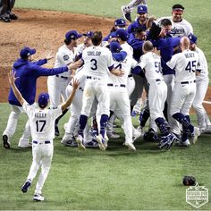 a group of baseball players standing on top of a field