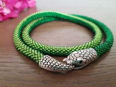 Handmade snake necklace in green glass seed beads. This is a particularly adorable piece of jewelry for a birthday, Christmas or Mother's Day gift.  With these snake necklaces you will certainly not go unnoticed! Length with clasp about: 20 inches (51 cm) Thickness about 0.31 inches (0.8 cm) The color of the photos may vary slightly depending on the monitor settings. Washing is not recommended. Handmade with Love! Adjustable Nickel Free Green Beaded Necklace, Green Round Beaded Nickel-free Necklace, Green Nickel-free Round Beaded Necklace, Beaded Snake Chain Jewelry Gift, Beaded Snake Chain Jewelry For Gifts, Handmade Snake-shaped Beaded Necklace For Gift, Adjustable Green Beaded Necklaces With Lobster Clasp, Adjustable Green Beaded Necklace With Lobster Clasp, Green Tiny Beads Jewelry For Crafting